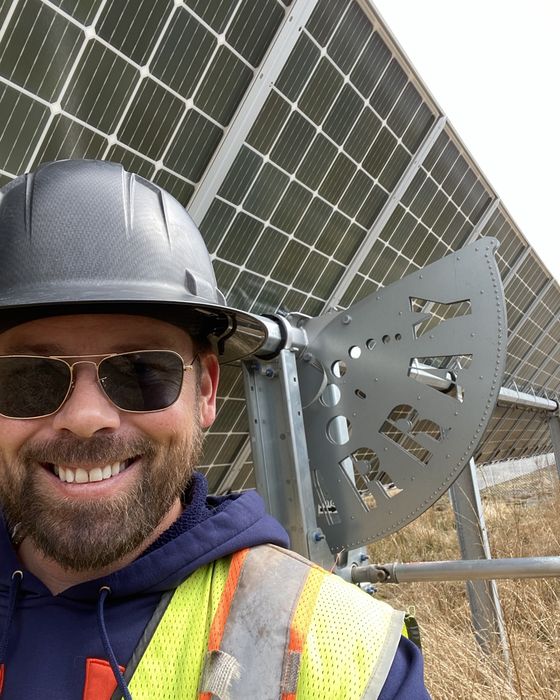 Close selfie beside a tracker drive gear.