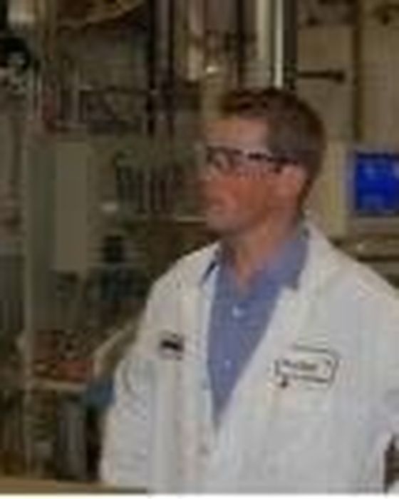 In a lab coat on a thin-film module production floor.
